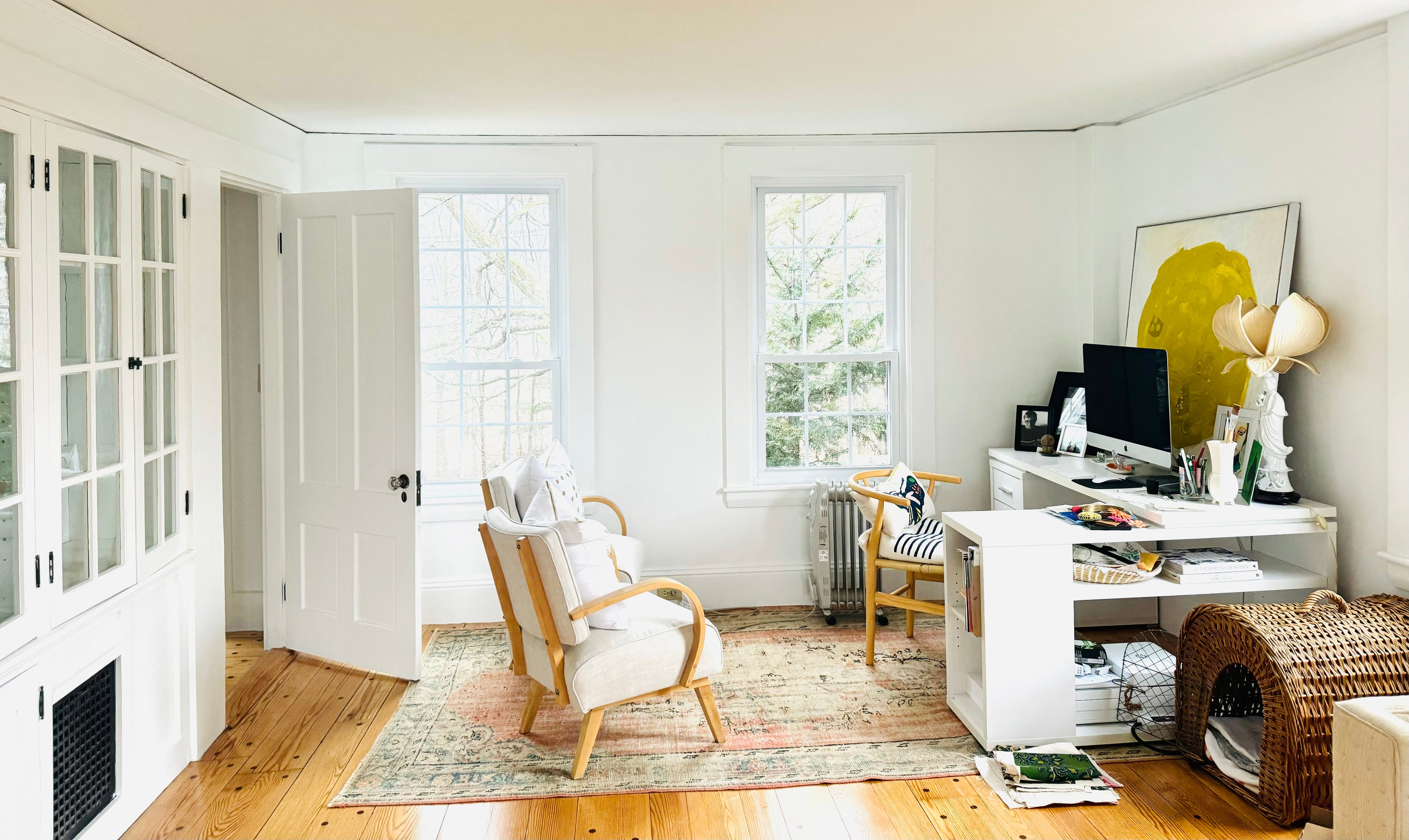 Erin Flett's modern home studio with a desk, chair, and decorative elements.